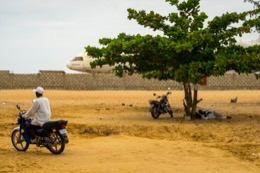 Barakah,-L1011-TriStar,-Lockheed-L1011,-abandoned-TriStar,-aircraft-wreck,-grounded-aircraft,-white-fuselage,-derelict-cockpit,-empty-cabin,-Cotonou-beach,-Cadjéhoun-beach,-Cotonou-Benin,-West-Africa,-Benin-airport,-Atlantic-coastline,-coastal-Benin,-corroded-wreck,-marine-rust,-deterioration,-salt-corrosion,-decay,-abandonment,-dereliction,-dilapidation,-environmental-erosion,-aviation-heritage,-industrial-archaeology,-failed-tourism-project,-open-air-museum,-urban-art,-colonial-relic,-Benin-history,-alternative-tourism,-architectural-curiosity,-aviation-history,-hajj-pilgrimage,-Air-Rum-airline,-defunct-carrier,-humanitarian-transport,-international-migration,-historical-traces,-industrial-heritage,-stranded-aircraft,-tourist-attraction,-urban-exploration,-ruin-photography,-beach-adventure,-Beninese-leisure,-amusement-park,-immersive-experience,-urban-safari,-overcast-sky,-sunset-beach,-tropical-storm,-coastal-erosion,-sea-salt,-Atlantic-Ocean,-white-sand,-coastal-vegetation,-gleaming-white,-nature-machine-contrast,-aerospace-geometry,-outstretched-wings,-empty-windows,-cabin-stairway,-cockpit-instruments,-time-displacement,-obsolescence,-suspended-time,-liminality,-aborted-transformation,-urban-memory,-unfinished-dream,-nature-industry-symbiosis,-tourism-ghost,-frozen-history