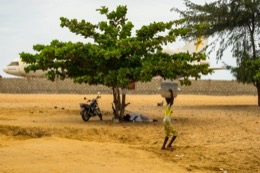 Barakah,-L1011-TriStar,-Lockheed-L1011,-abandoned-TriStar,-aircraft-wreck,-grounded-aircraft,-white-fuselage,-derelict-cockpit,-empty-cabin,-Cotonou-beach,-Cadjéhoun-beach,-Cotonou-Benin,-West-Africa,-Benin-airport,-Atlantic-coastline,-coastal-Benin,-corroded-wreck,-marine-rust,-deterioration,-salt-corrosion,-decay,-abandonment,-dereliction,-dilapidation,-environmental-erosion,-aviation-heritage,-industrial-archaeology,-failed-tourism-project,-open-air-museum,-urban-art,-colonial-relic,-Benin-history,-alternative-tourism,-architectural-curiosity,-aviation-history,-hajj-pilgrimage,-Air-Rum-airline,-defunct-carrier,-humanitarian-transport,-international-migration,-historical-traces,-industrial-heritage,-stranded-aircraft,-tourist-attraction,-urban-exploration,-ruin-photography,-beach-adventure,-Beninese-leisure,-amusement-park,-immersive-experience,-urban-safari,-overcast-sky,-sunset-beach,-tropical-storm,-coastal-erosion,-sea-salt,-Atlantic-Ocean,-white-sand,-coastal-vegetation,-gleaming-white,-nature-machine-contrast,-aerospace-geometry,-outstretched-wings,-empty-windows,-cabin-stairway,-cockpit-instruments,-time-displacement,-obsolescence,-suspended-time,-liminality,-aborted-transformation,-urban-memory,-unfinished-dream,-nature-industry-symbiosis,-tourism-ghost,-frozen-history