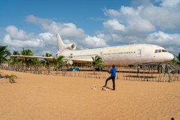 Aéroport-de-Cotonou;-Afrique-de-lOuest;-Avion-abandonné;-Barakah;-Bénin;-Carcasse-davion;-Cocotier;-Cotonou;-Épave;-Homme;-Kaleidos;-Kaleidos-images;-La-parole-à-limage;-Lockheed-L-1011;-Plage-de-Cadjéhoun;-Tarek-Charara;-Téléphone-portable;-TriStar;-Vie-quotidienne