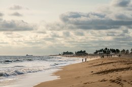 Atlantic-Ocean;-Beach;-Benin;-Cargo-ship;-Coastline;-Coconut-palm;-Cotonou;-Fidjrossè;-Gulf-of-Guinea;-Kaleidos;-Kaleidos-images;-La-parole-à-limage;-Late-afternoon;-Overcast-sky;-Route-des-Pêches;-Stories-Pictures;-Tarek-Charara;-Walkers;-Walking;-West-Africa